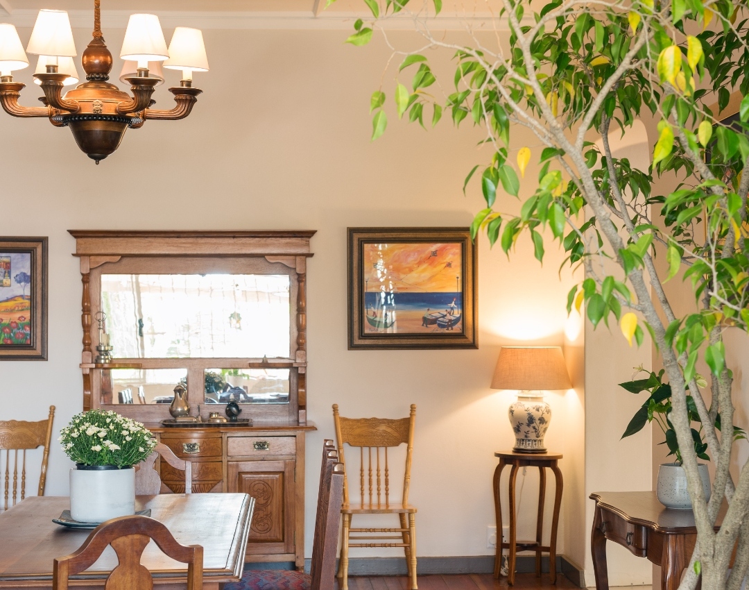 Shared dining and lounge area with antique furnishings at House Falcon Guest House